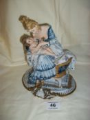 A Capo Di Monte figure of a Mother and Baby