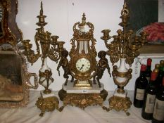 A Victorian 3 piece clock garniture surmounted cherub