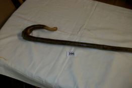 A shepherd's crook with carved handle
