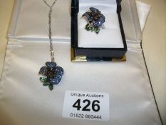An 18ct whit gold sapphire and emerald stone set pendant and matching ring (Depicciiotto, New York)