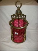 A Victorian brass and cranberry glass lantern
