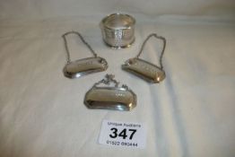 3 silver decanter labels and a silver napkin ring