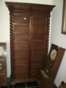 A large oak continental cabinet with drop fronts