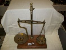 A set of Victorian brass scales and weights by Pike and Elliman