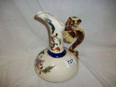 An unusual pottery ewer with griffin handle