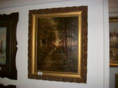 An oil on canvas 'Sunset in the New Forest' signed but indistinct, possibly T Williamson