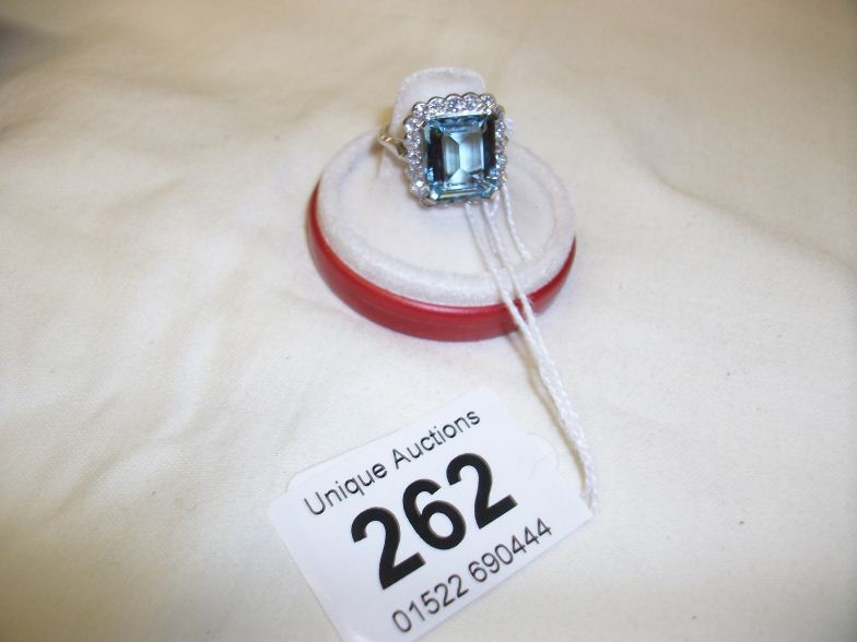 An 18ct white gold ring set with square cut 4.5ct aquamarine surrounded by approximately 1ct of