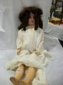 A German porcelain doll marked S H 914 with composition body