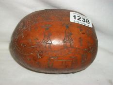 An ethnic carved seed case