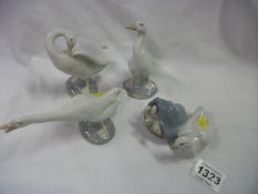 3 Lladro geese and a Lladro duck with ducklings