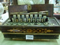 An old inlaid concertina with mother of pearl keys and in wooden case (case a/f)