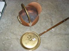 A copper coal scuttle and a brass warming pan