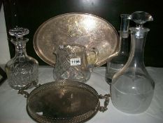 2 silver plated trays, 3 decanters and a jug