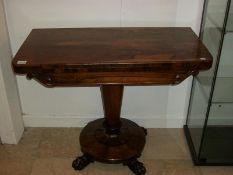 A Victorian rosewood fold over table