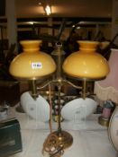 A brass adjustable student lamp with glass shades