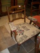 A mahogany elbow chair with upholstered seat