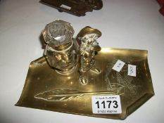 A brass inkstand surmounted figure
