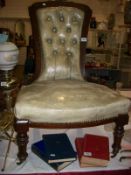 A Victorian mahogany ladies chair with leather upholstery