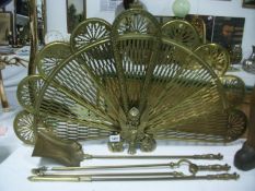 A brass fan fire screen together with a set of brass fire irons