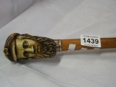 A Walking stick with sailor's head handle
