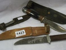 3 old knives in leather sheaths