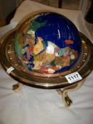 A jewelled globe on brass stand
