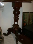 A mahogany tripod table with carved base and leather inset top