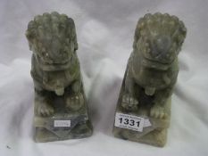 A pair of carved stone Dogs of Foo