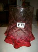 A large cranberry glass lamp shade