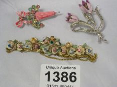 A floral necklace and 2 brooches
