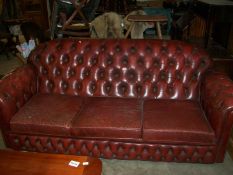 A red leather Chesterfield sofa