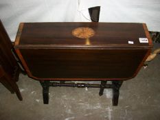 A mahogany Sutherland table with shell inlay (inlay a/f)