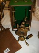 A brass microscope in wooden case