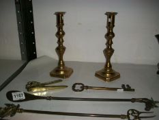 A pair of brass candlesticks, shoe horn, toasting fork, nut crackers and key