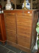 An oak tambour front cabinet