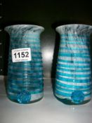 A pair of blue studio glass vases