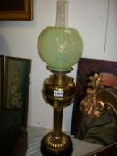 A brass oil lamp with shade