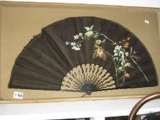 A black silk hand painted fan