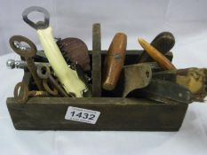 A quantity of old corkscrews, keys etc