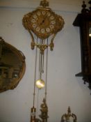 A Sohu brass wall clock with weights and pendelum