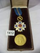 A Spanish enamelled medal and a coin