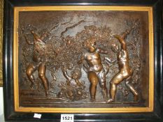 A framed bronze cherub plaque