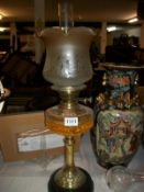 A Victorian oil lamp on pot base and with later shade