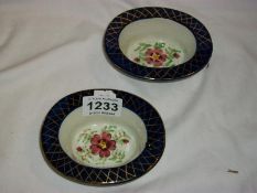 A pair of hand painted dishes