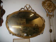 An oval gilt framed mirror