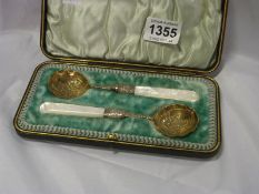 A cased pair of spoons with mother of pearl handles