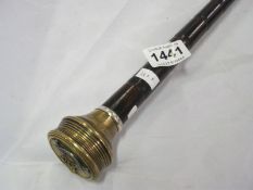 A walking stick with military badge on handle