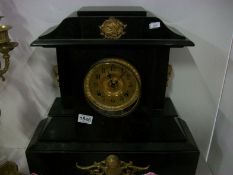 A large black marble mantel clock