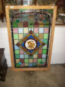 A pine framed stained and leaded glass panel (overall size 110 x 68.5 cm)