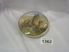 A pot lid with shipping scene